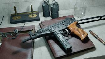 Screenshot of OTs 9 submachine gun on top of notebook placed on white desk near pen