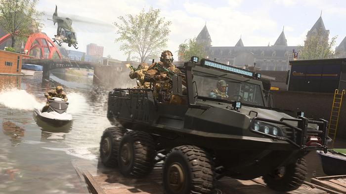 Screenshot of Warzone players riding in an amphibious vehicle with a jet ski in the background